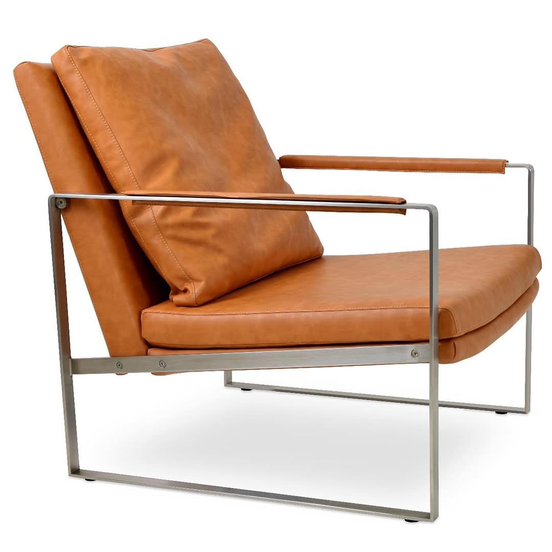 Modern tan leather lounge chair with a stainless steel frame and cushioned seat and backrest.